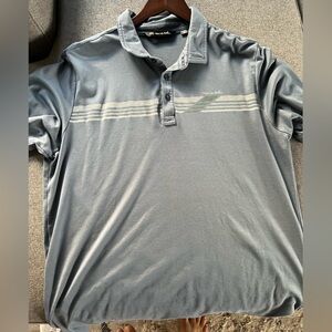 Travis Mathew dark blue with green stipe golf polo